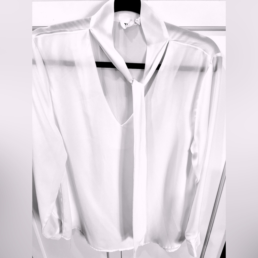 White long sleeve blouse with tie at neck. Fits M/L 8-10. Machine wash